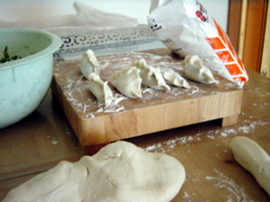 Little parcels of pork-chives-ginger-cabbage mixture, sealed inside a dough envelope.