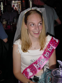 Decked out in a veil and sash. I kept mis-reading the sash as 