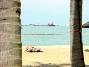 Baking in the sun, as the tankers look on from the sea.